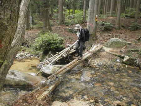 細い橋を渡る同行者