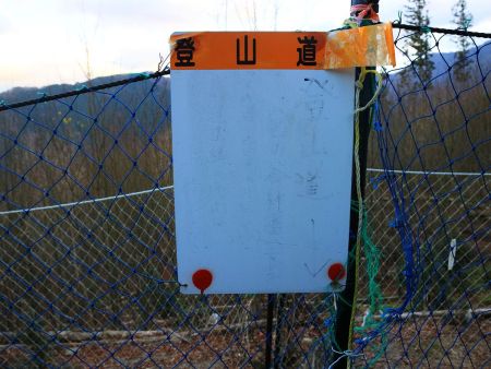 ここの分岐で薄っすらと宮の谷林道へ下ると矢印が書いてあった。矢印通りだとネットを越えないといけない